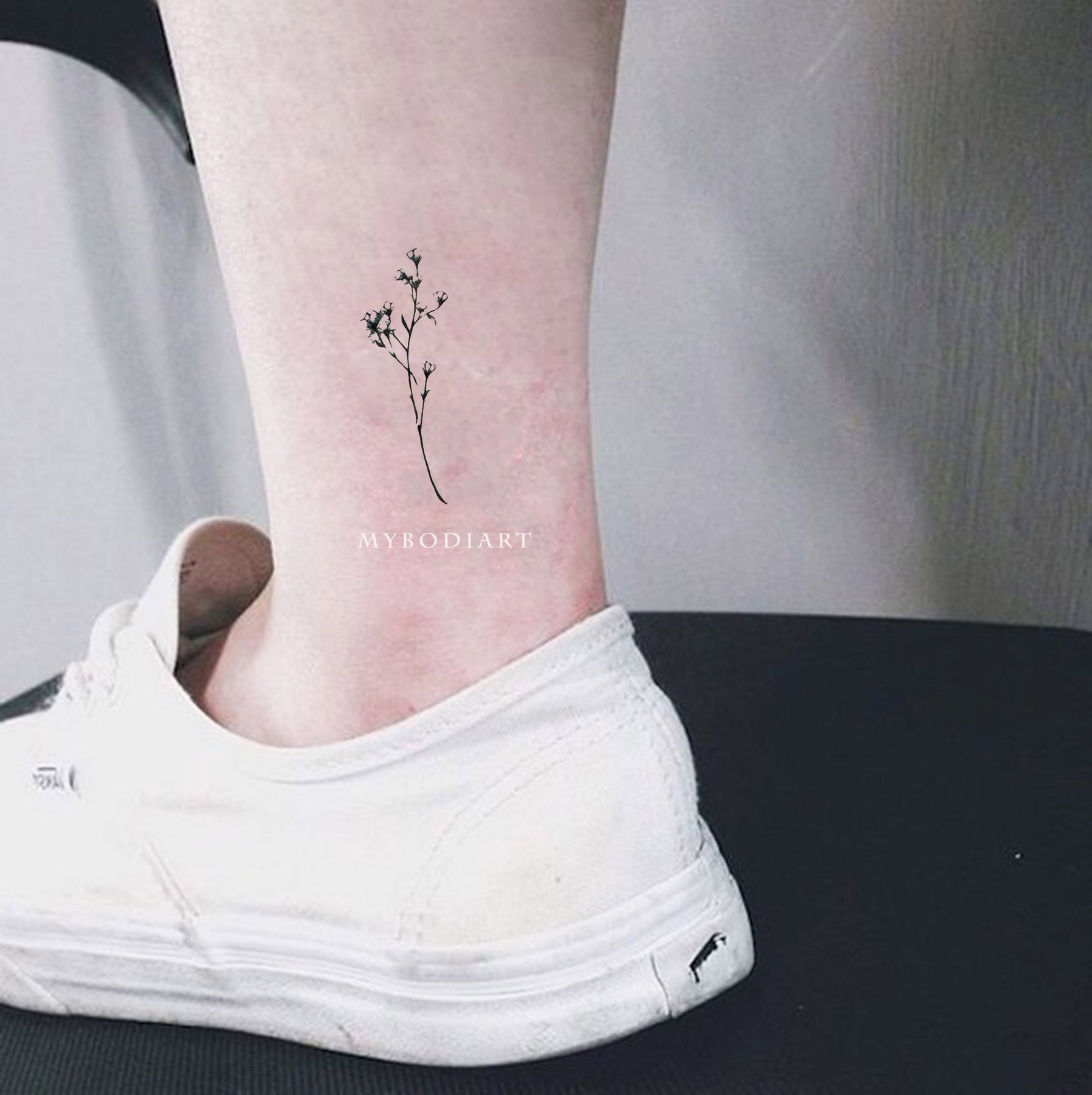 Delicate flowers on the left ankle - Tattoogrid.net