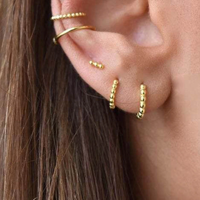 Pretty Minimalist Gold Hoop Huggie Earrings Ear Piercing Ideas for Women - www.MyBodiArt.com